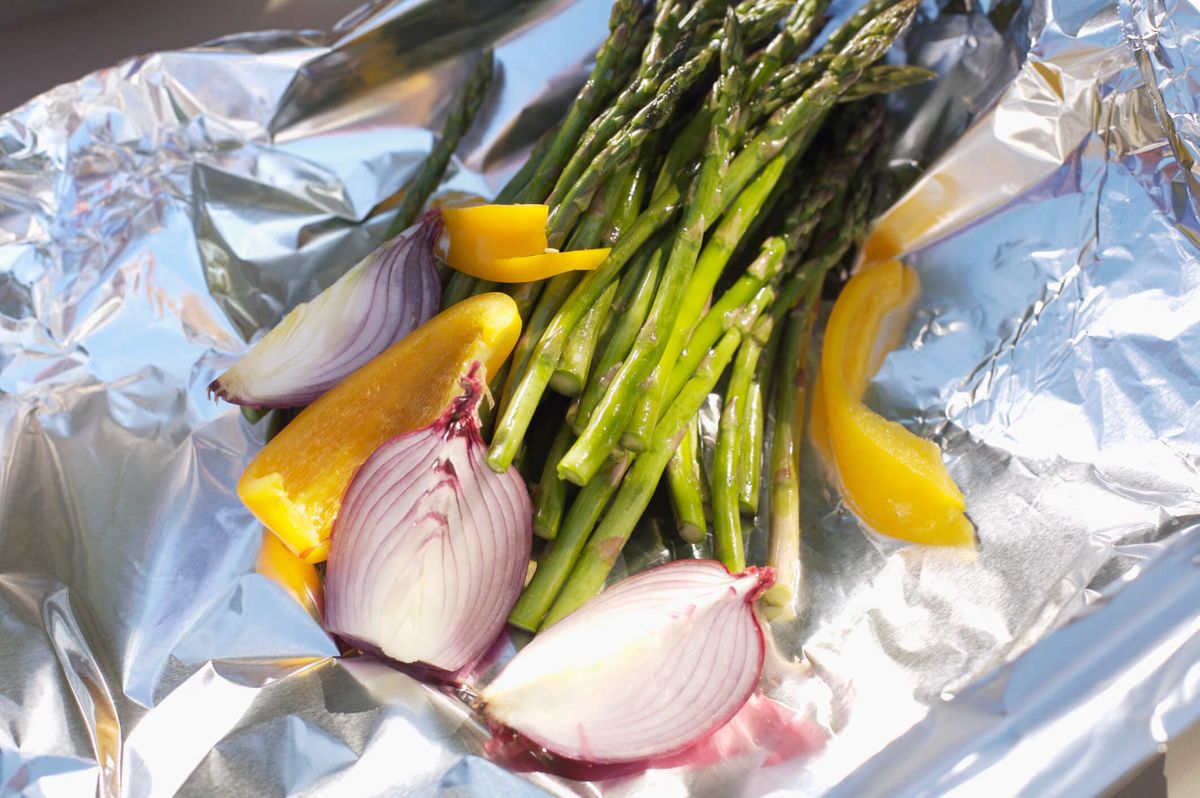 asparagus, onions, bell pepper on aluminum foil