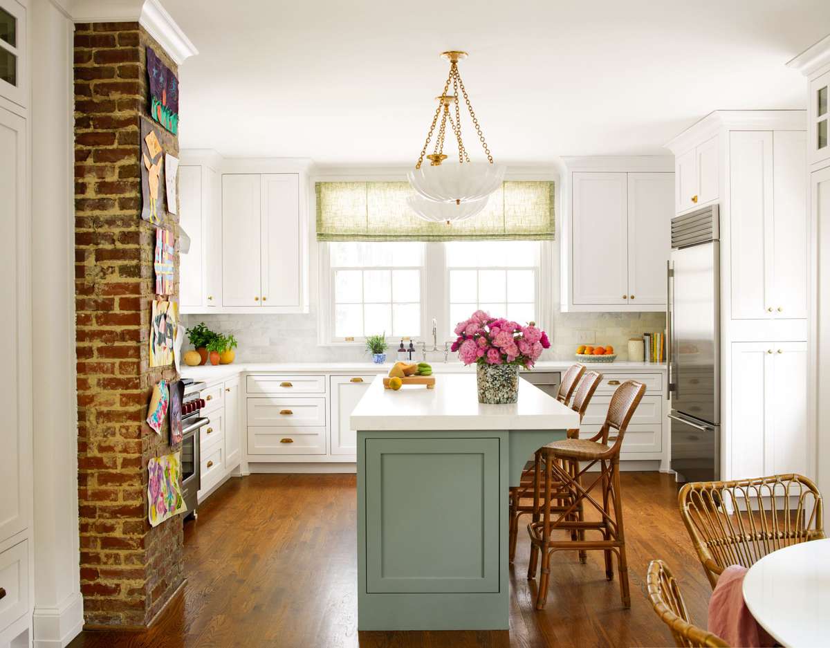 White Kitchen with Green Island and Exposed Brick Wall