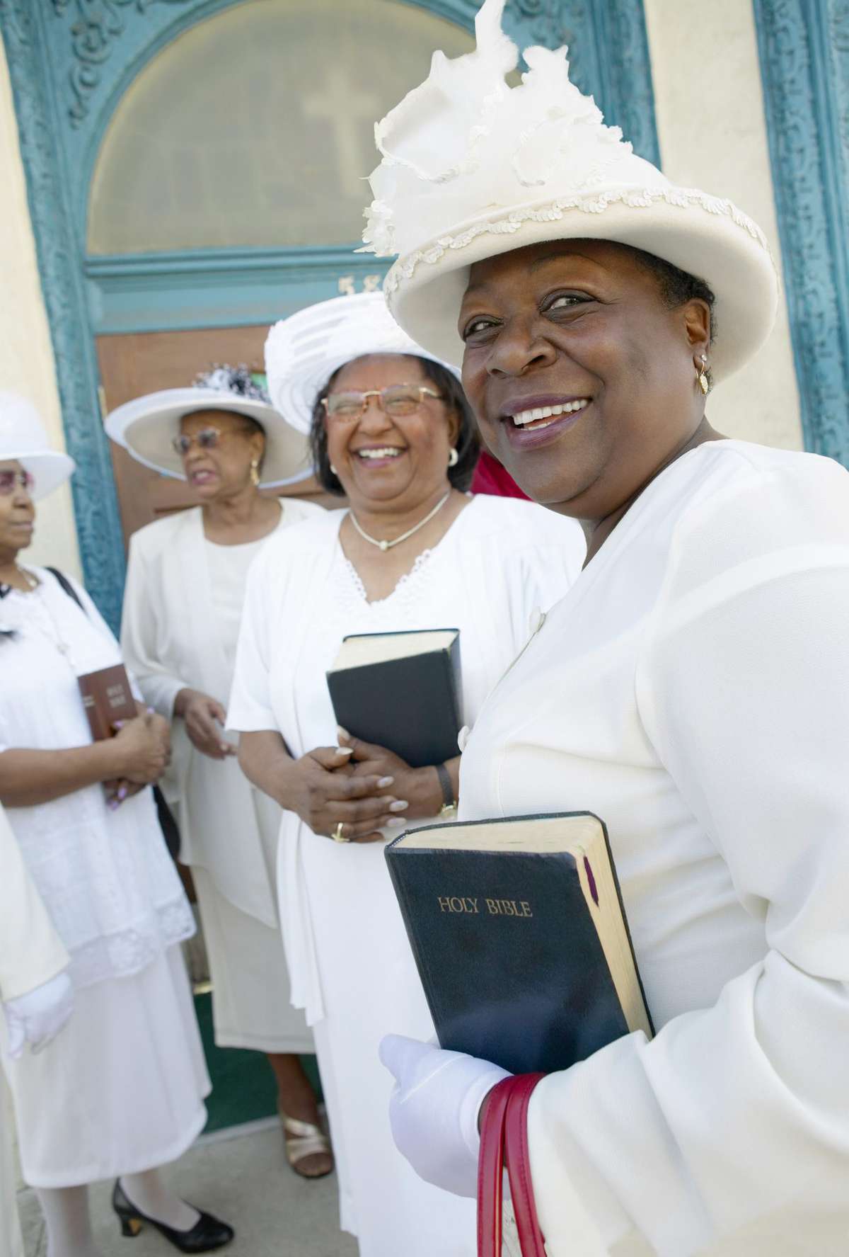 Congregation of Women Dressed in White Clothing Standing Outside a Church