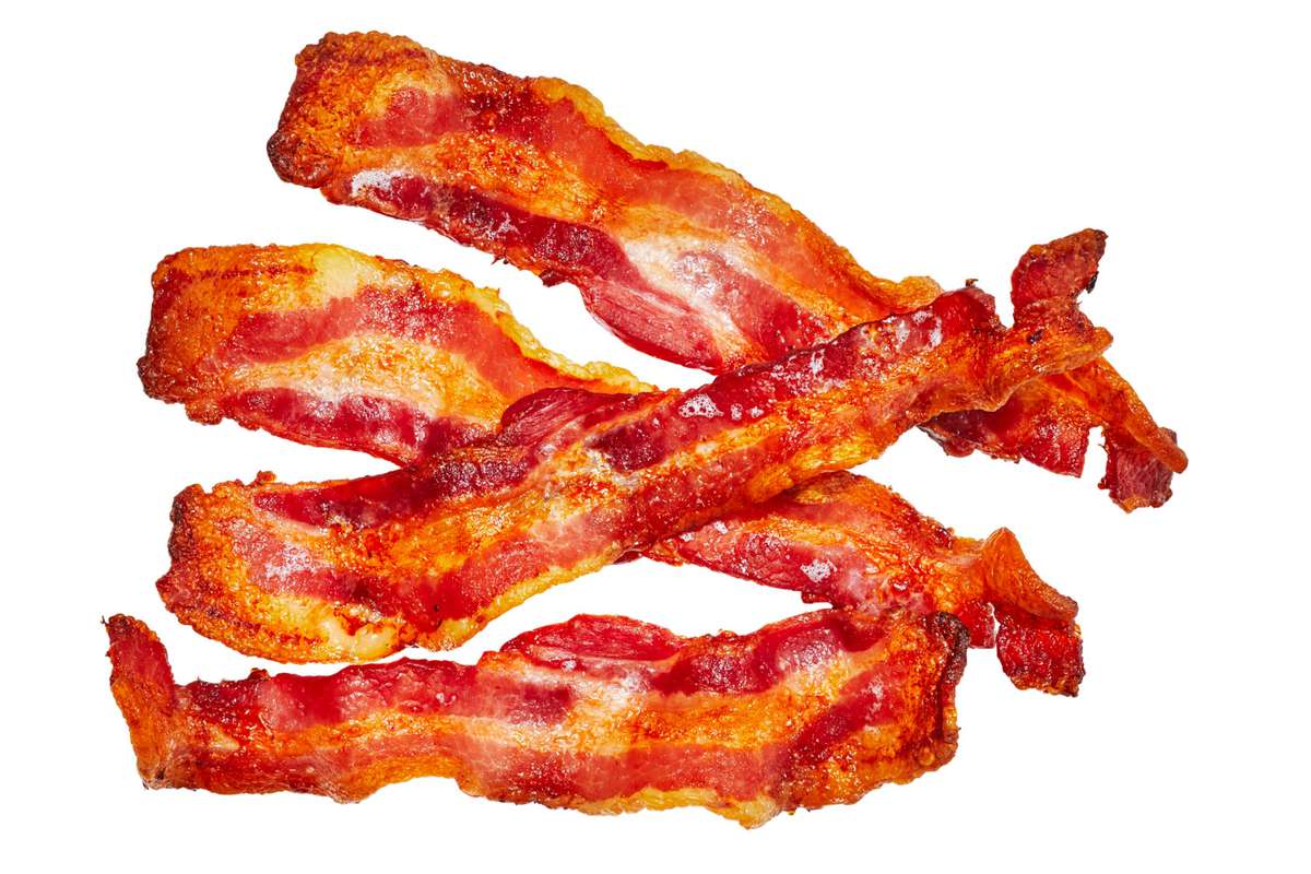 four slices of crispy bacon on a white background