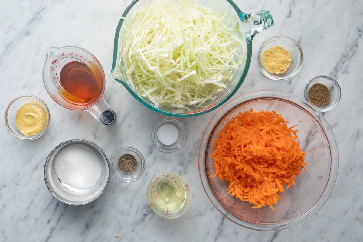 ingredients for South Carolina Slaw in bowls on a marble counter