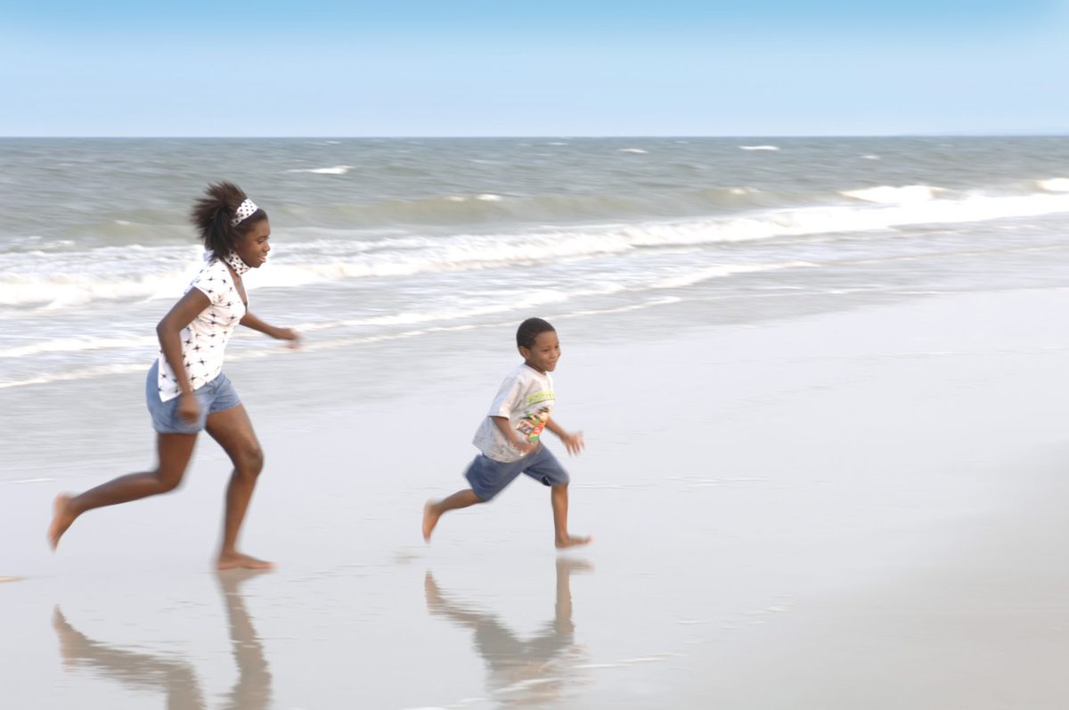Brother and sister playing on beach at Amelia Island