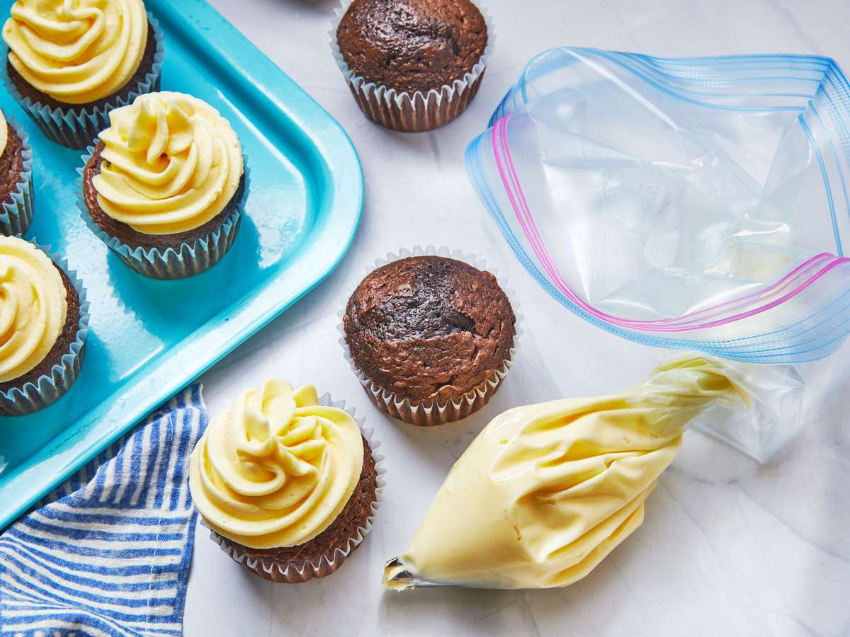 frosted cupcakes and a piping bag made from a freezer bag