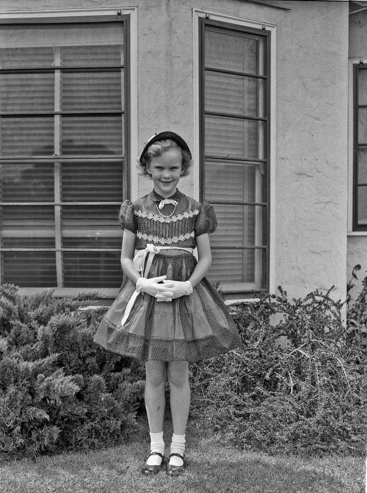 Black and white photo of girl in smocked dress