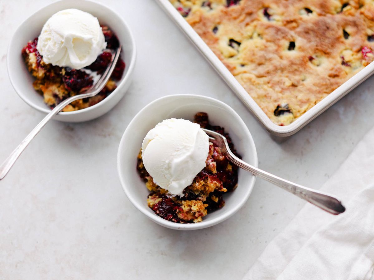 two bowls of cherry dump cake with ice cream on top