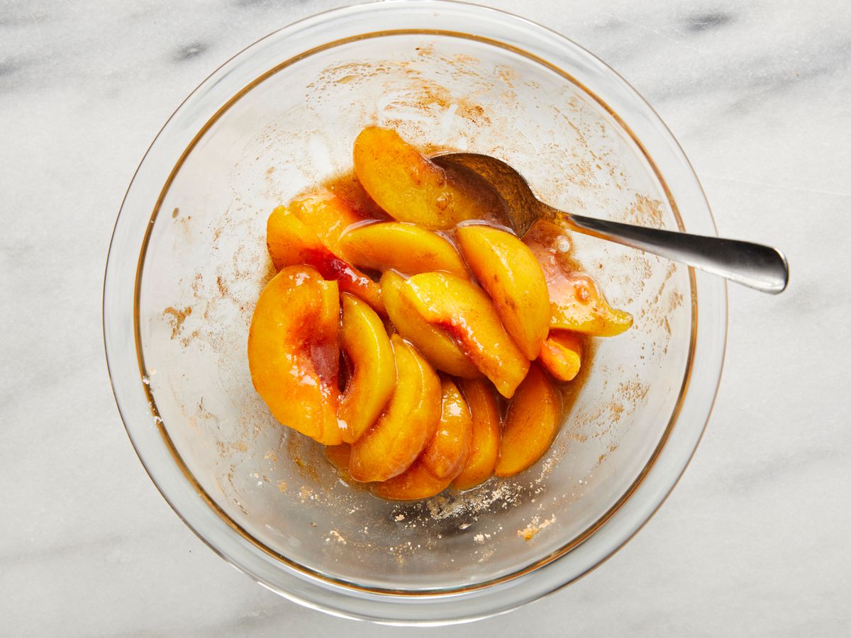 syrupy peaches in medium bowl