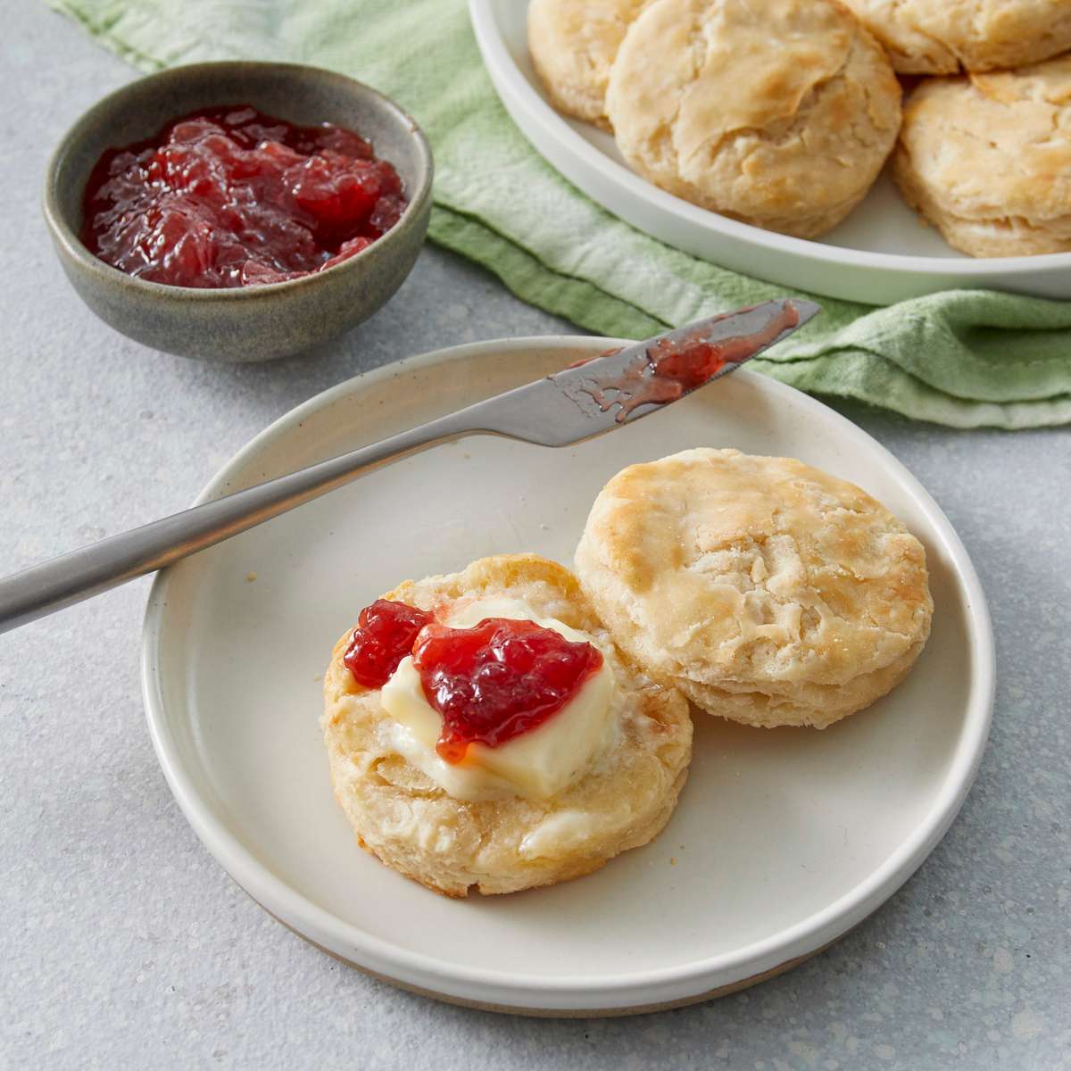 Our Favorite Buttermilk Biscuit on a plate with jam and butter