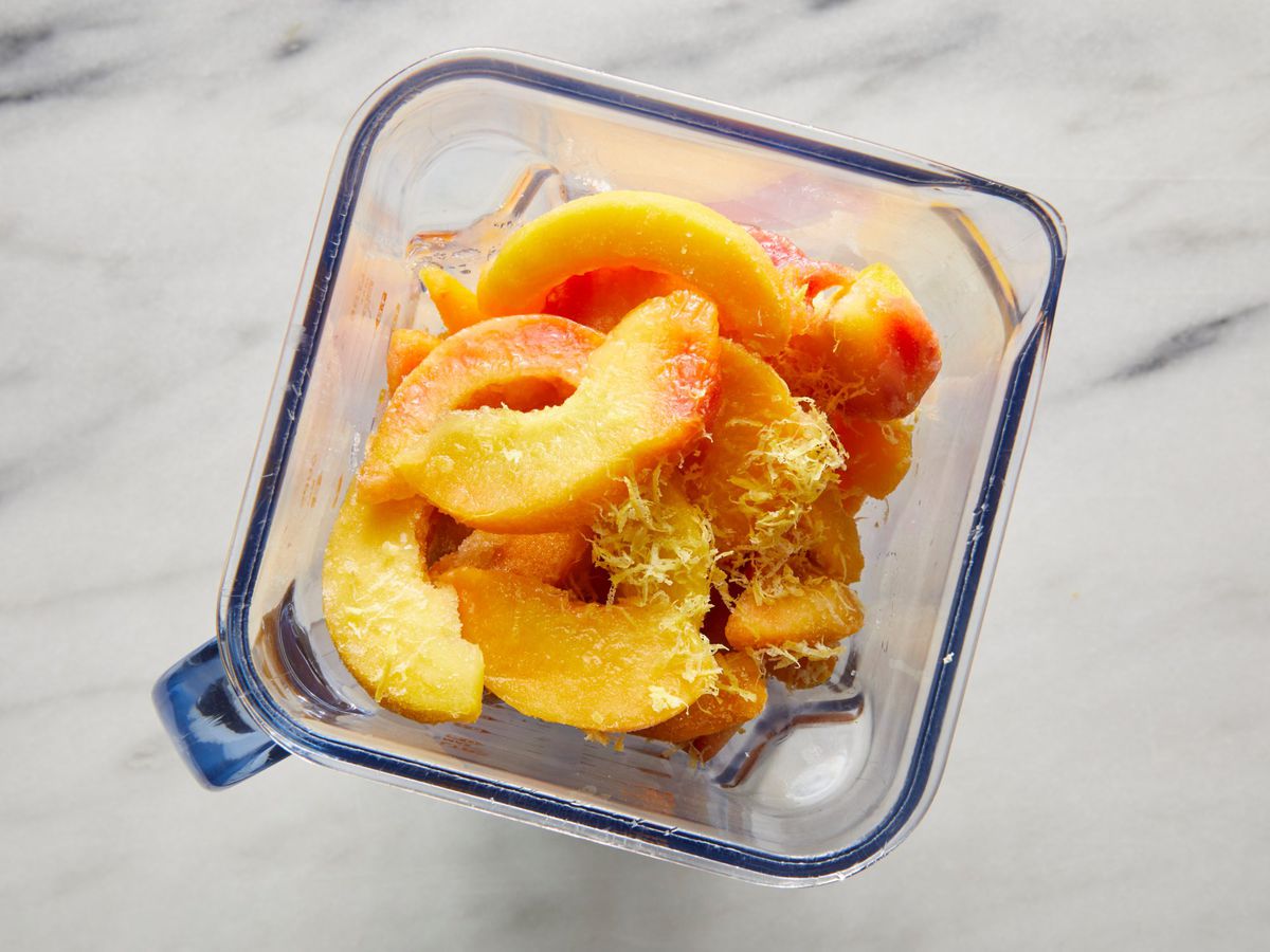 frozen peaches and a lemon zest in a blender