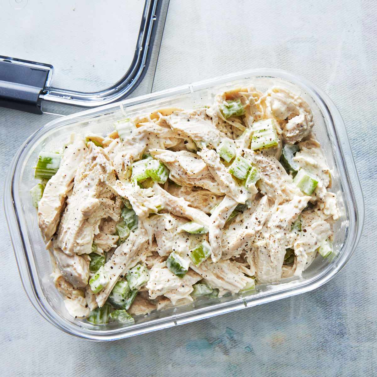 chicken salad in a container with lid on side