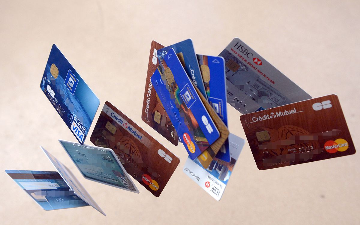 Credit cards falling down are pictured, on February 5, 2013  in Rennes, western France. French police has arrested, early this morning in Paris and in several French and overseas departments, 22 people in connection with the trade of credit cards numbers
