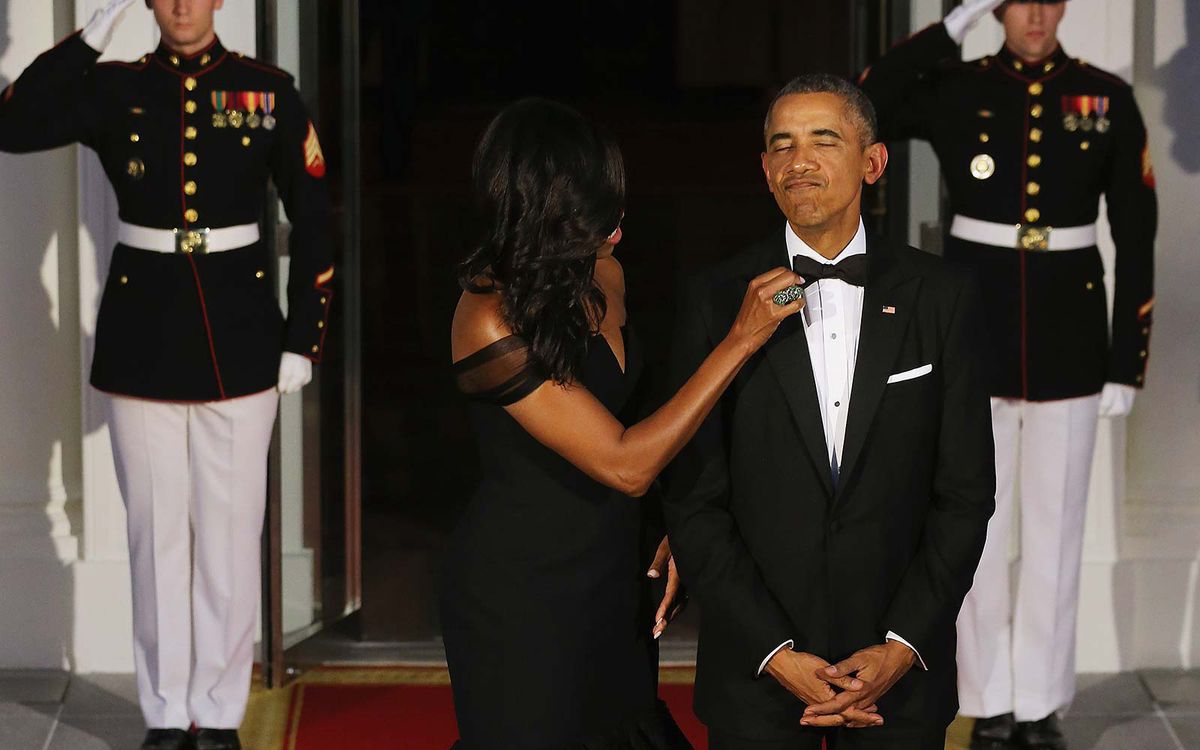 U.S. First Lady Michelle Obama straightens U.S. President Barack Obama's tie