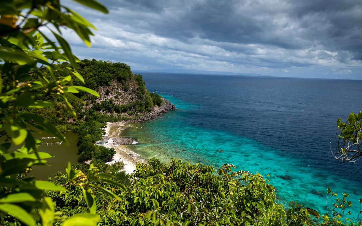 View from top of a hill to Apo Reef Natural Park. Apo island, Philippines