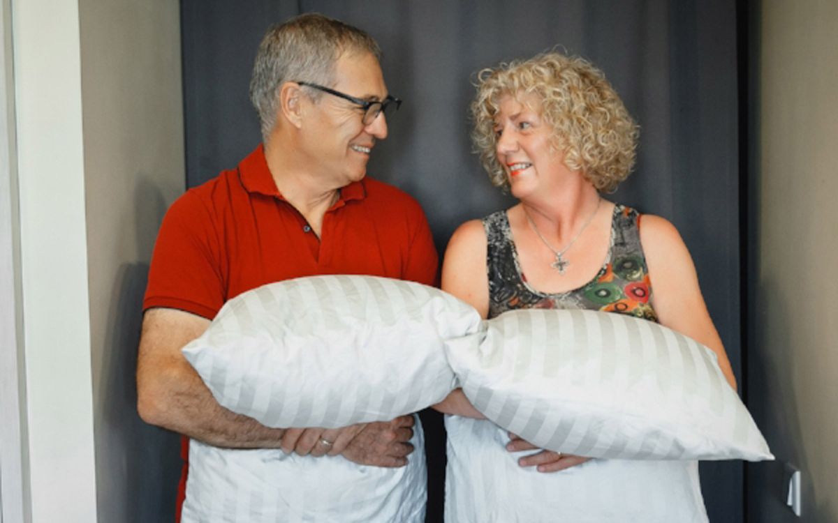 Michael and Debbie Campbell carrying pillows