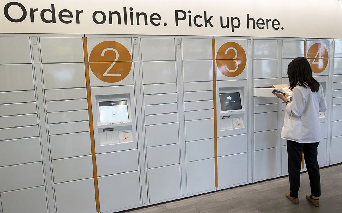 A student retrieves a package at the Amazon.com Inc. kiosk on the University of California, Berkeley campus in Berkeley, California, U.S., on Wednesday, Oct. 12, 2016. By the end of the year, Amazon will have staffed pickup kiosks serving more than 500,00