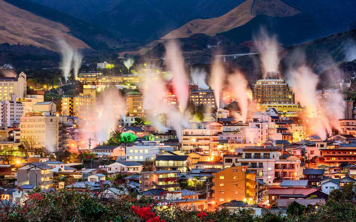 Beppu, Japan cityscape with hot spring bath houses with rising steam.