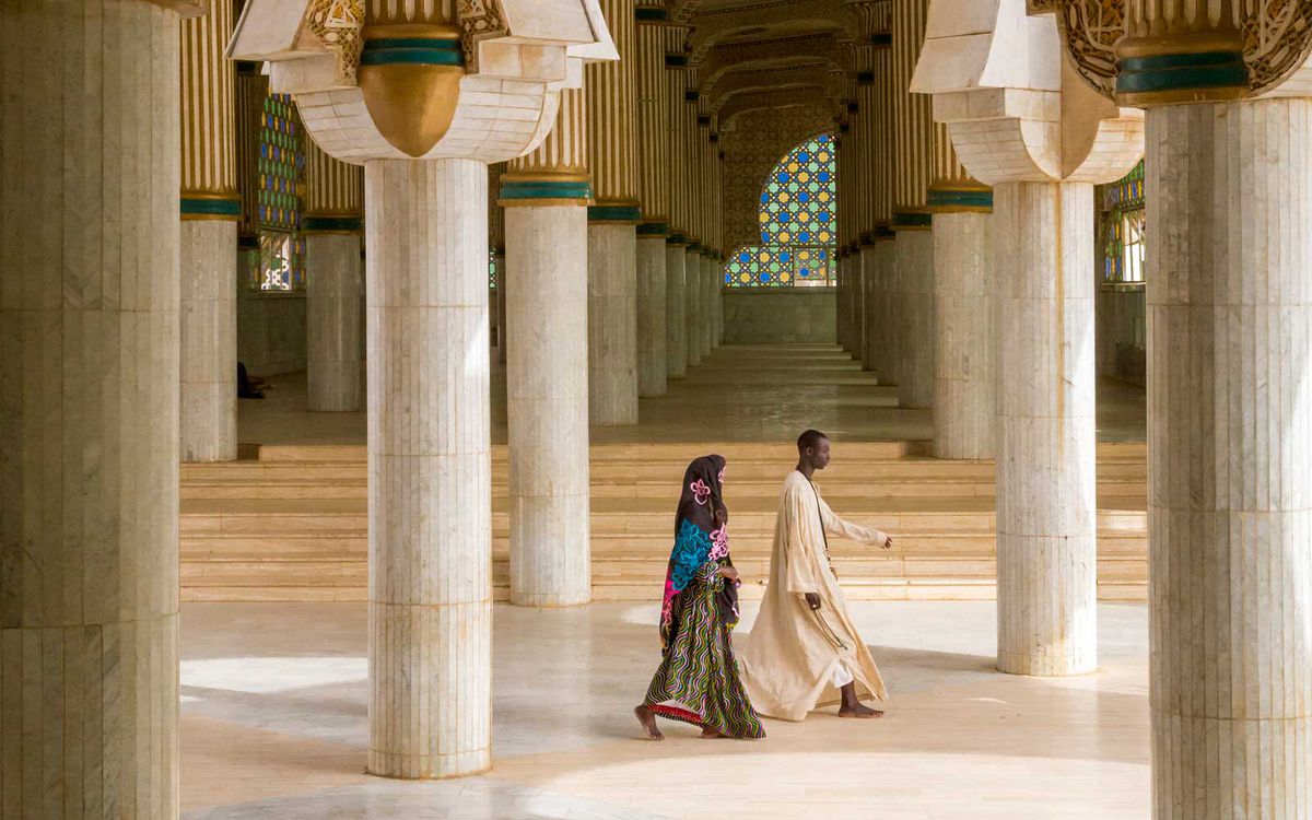 Walking to prayer at the Grand Mosque in Touba, Senegal