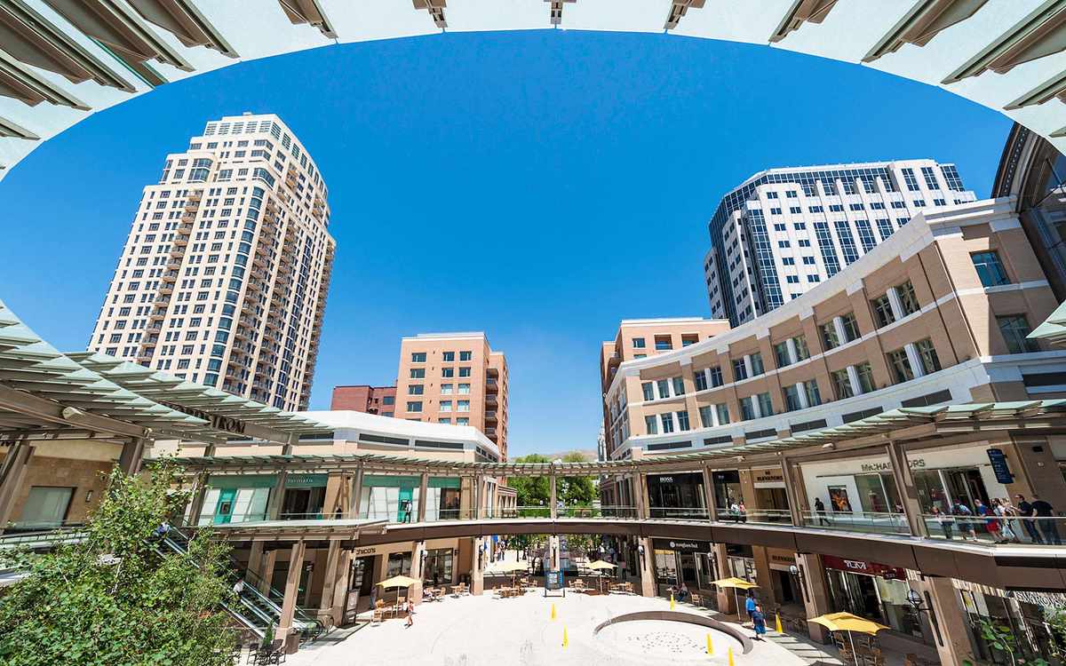"Salt Lake City, Utah, USA - May 14th, 2012: Clear blue desert skies over the City Creek Center shopping mall complex in downtown Salt Lake City as shoppers stroll through the open air fountain plaza past stores and restaurants."