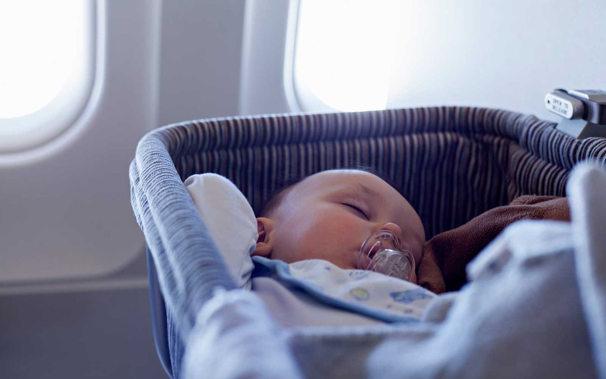 Baby Sleeping In Bassinet On Airplane