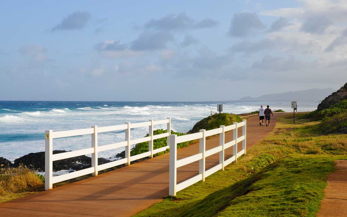 Walking by seaside on coastal path in Kappa, Hawaii
