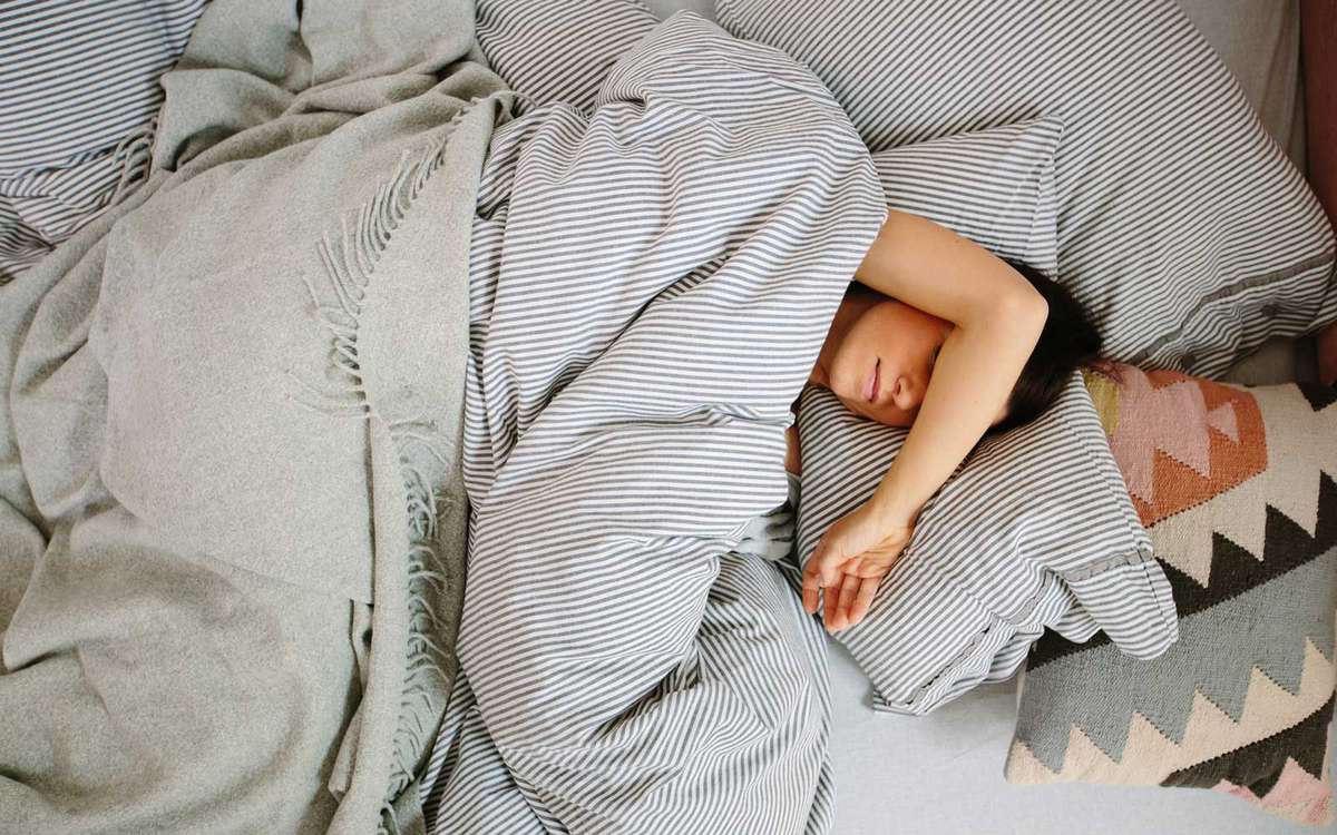 Overhead view of woman lying in bed sleeping