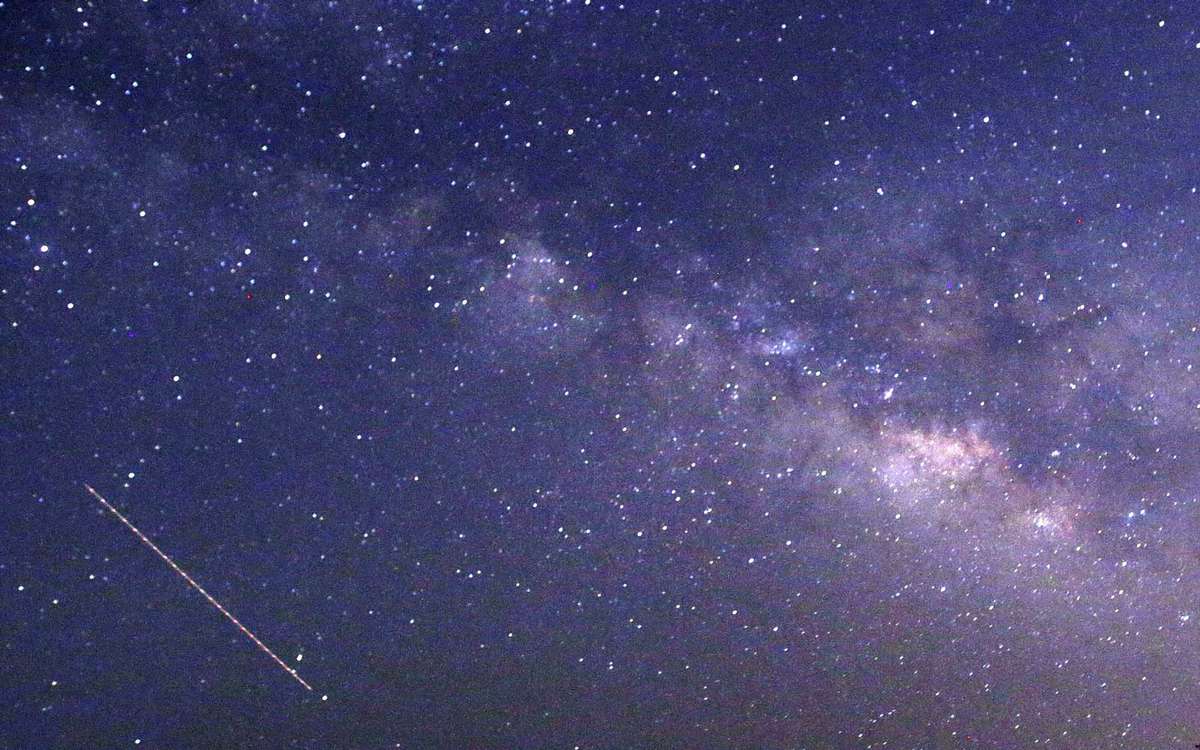 This long-exposure photograph taken on April 23, 2015 on Earth Day shows Lyrids meteors shower passing near the Milky Way in the clear night sky of Thanlyin, nearly 14miles away from Yango