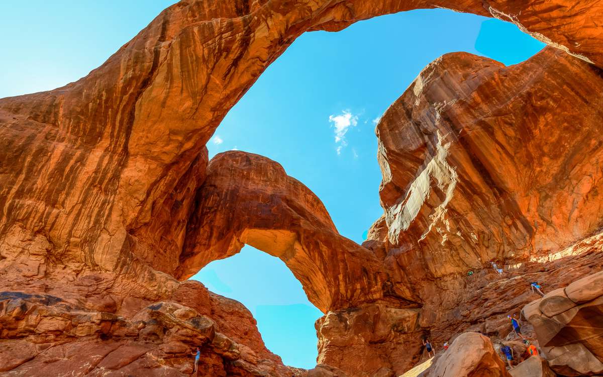 Tourists Explore Double Arch, Arches National Park, Moab Utah