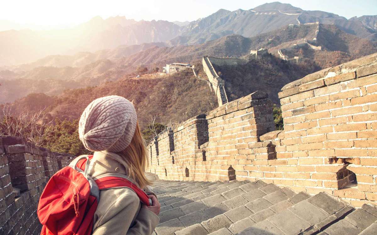 Young woman hiking the Great Wall of China
