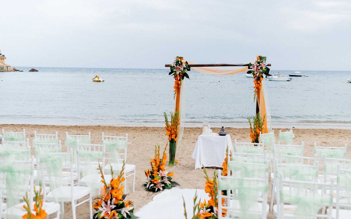 Chairs and wedding arbor on a beach