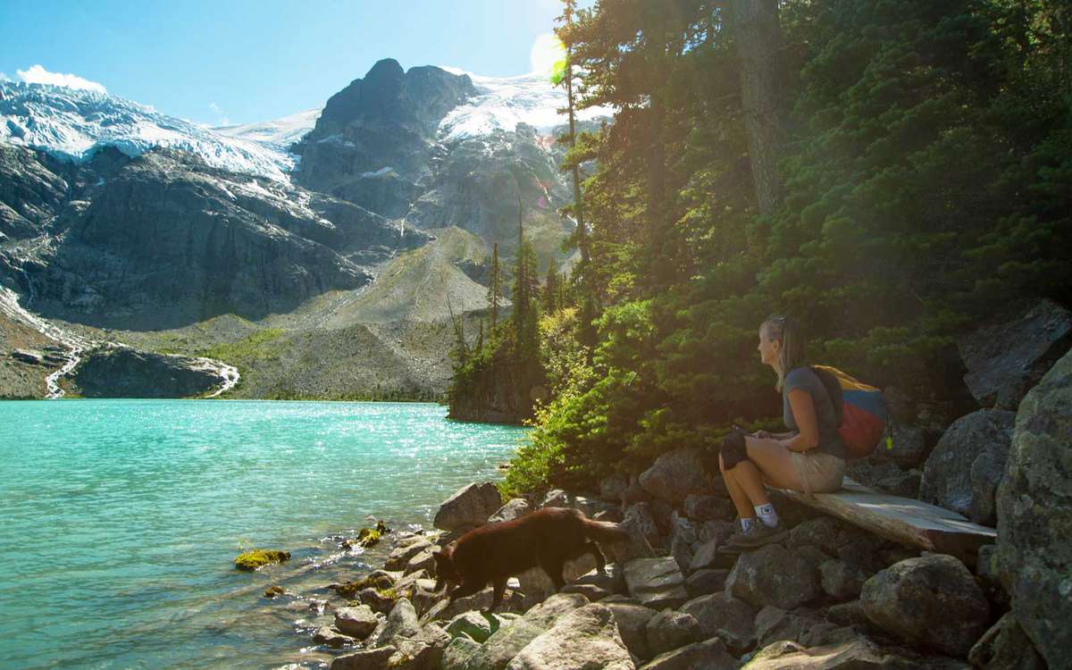 Woman resting beside Joffre Lake, Canada