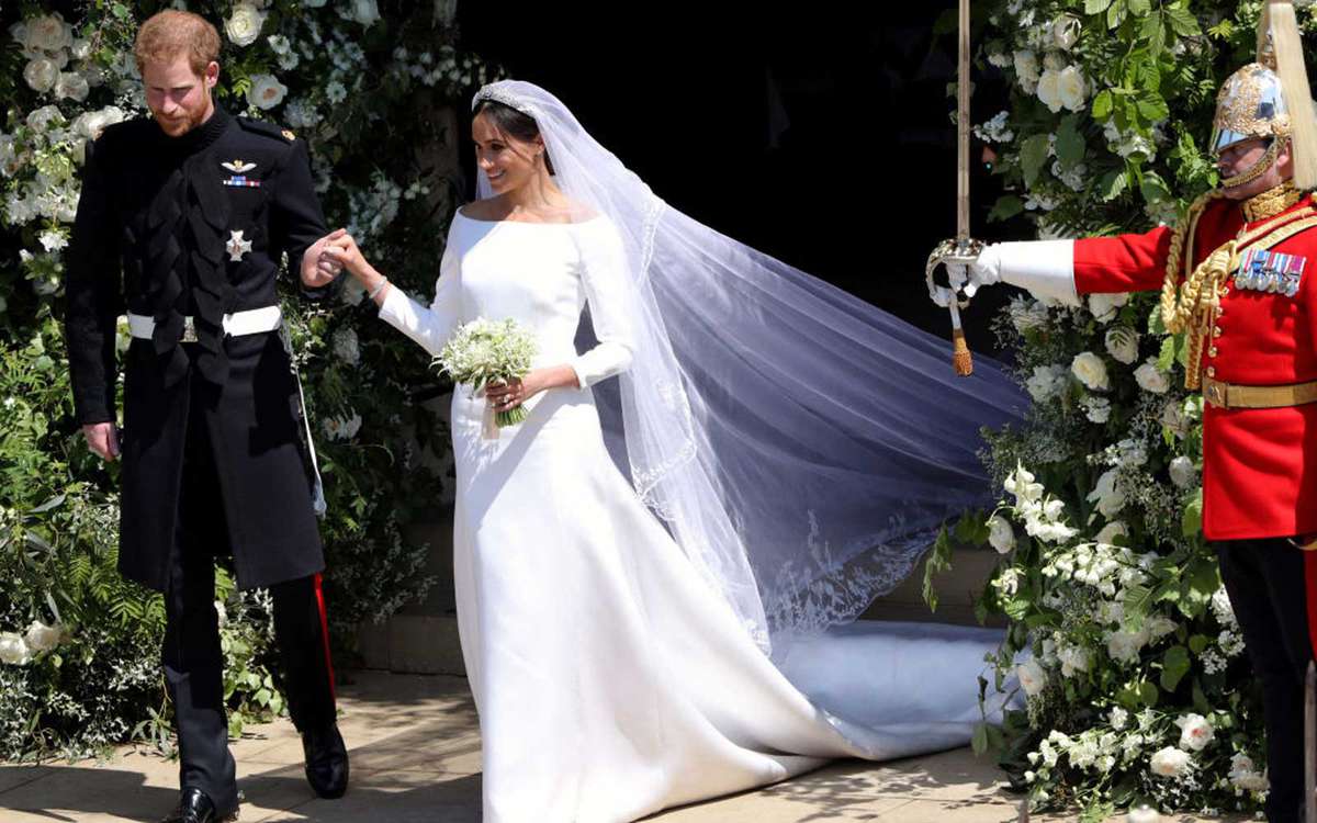 Britain's Prince Harry, Duke of Sussex and his wife Meghan, Duchess of Sussex emerge from the West Door of St George's Chapel, Windsor Castle, in Windsor, on May 19, 2018 after their wedding ceremony.