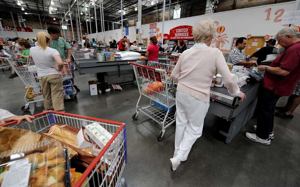 People shop at the reduced cost, high volume Costco supermarket warehouse