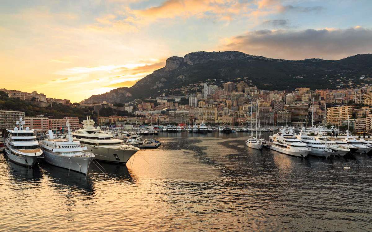 Vivid sunset over super yachts, glamorous harbour of Monaco