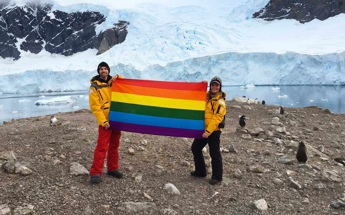 Pride flag in Antarctica, with Planting Peace founder Aaron Jackson