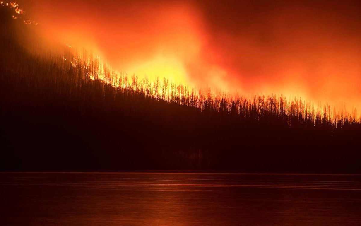 Sunday, Aug. 12, 2018, a fire burns next to Lake McDonald in Glacier National Park in northwest Montana.