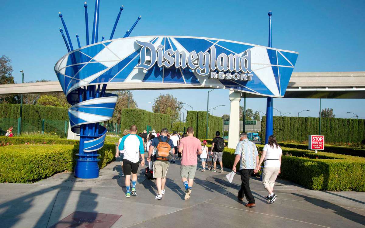 Visitors arriving at entrance of Disneyland Resort in Anaheim, CA