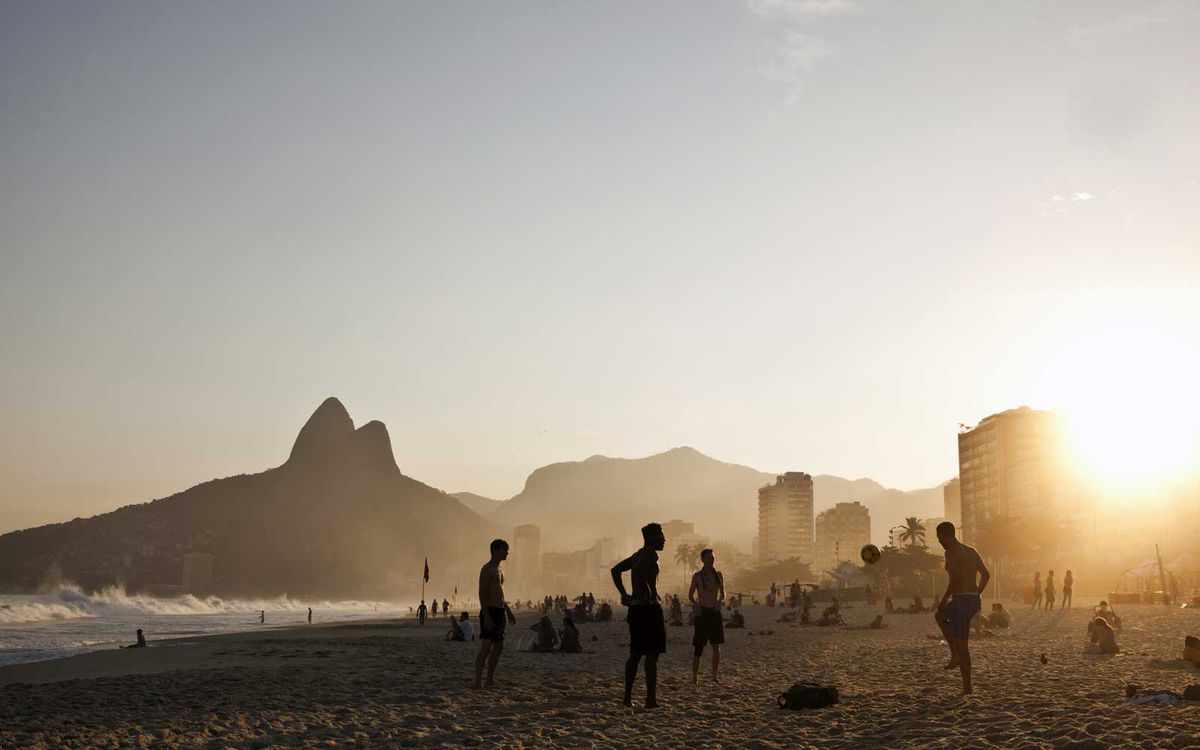 Playing soccer at sunset on Ipanema beach, Rio de Janeiro, Brazil