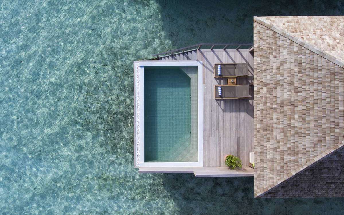 Aerial view of an overwater pool at the Hurawalhi resort in the Maldives