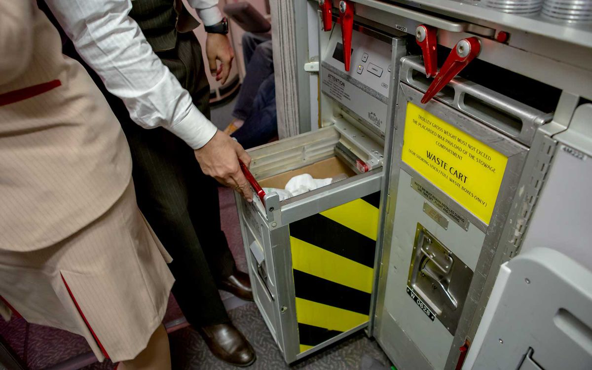 Emirates has a compacting system that allows for cabin crew to dispose of waste on flights in a cleanly manner.