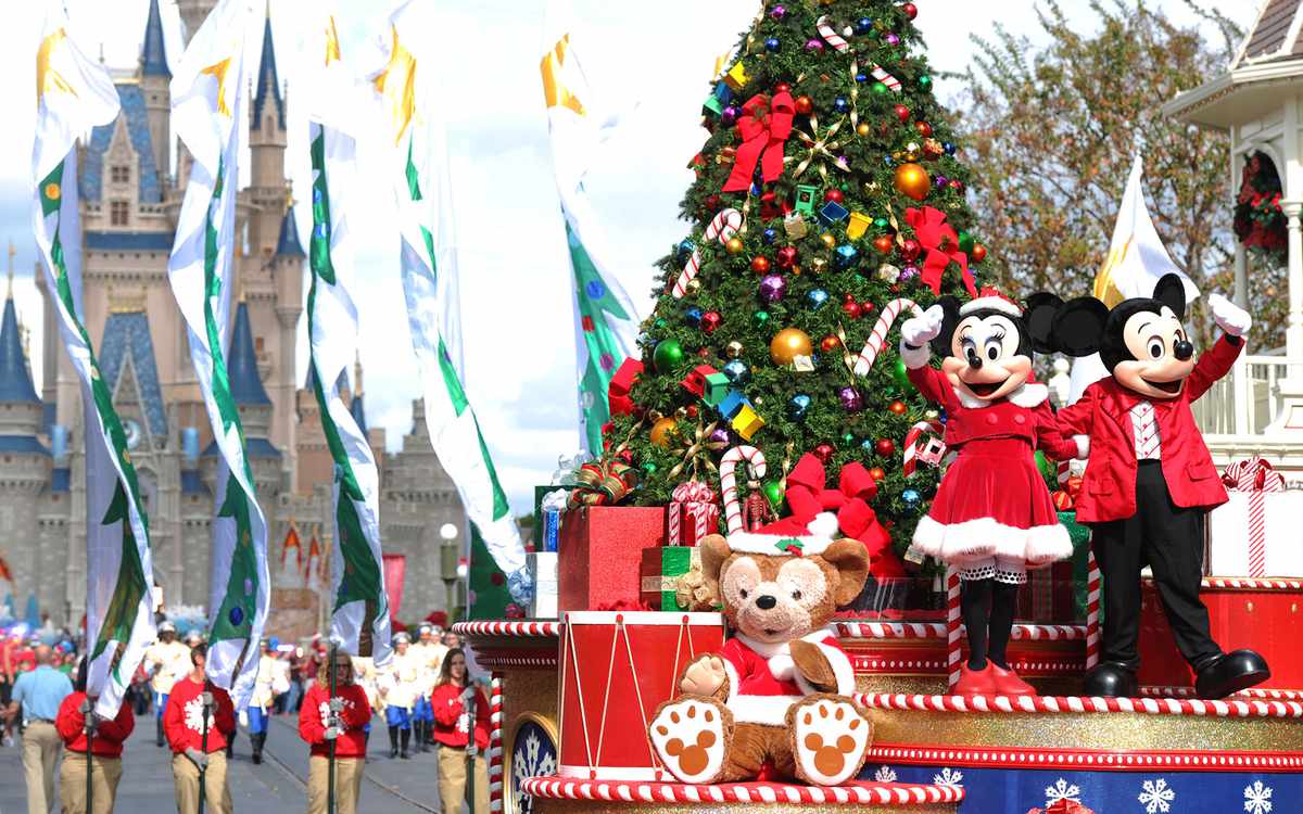 LAKE BUENA VISTA, FL - DECEMBER 01:  In this handout photo provided by Disney, Mickey and Minnie Mouse wave to the crowd while taping the "Disney Parks Christmas Day Parade" TV special in the Magic Kingdom park at Walt Disney World on December 1,2012 in L