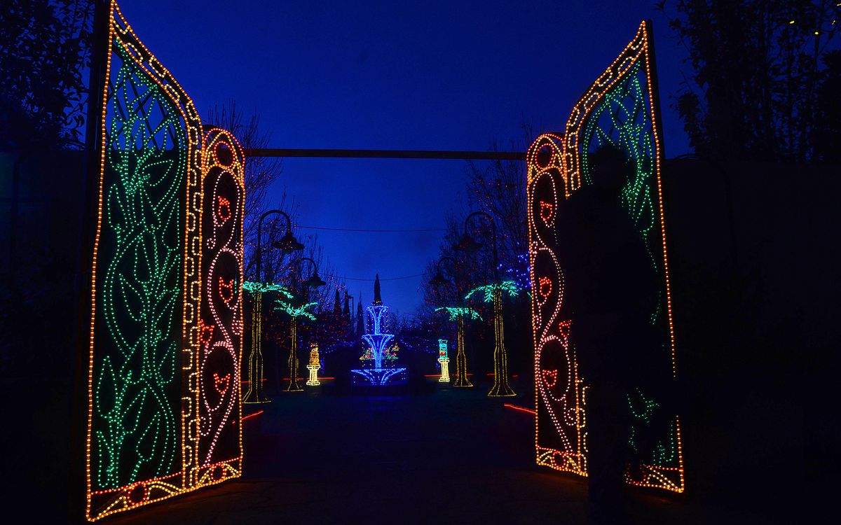 EAMCPP Albuquerque, NEW MEXICO, USA. 17th Nov, 2014. 111714.A man walks in front of the gates of the Moorish Garden that is part of this year's River of Lights at the Albuquerque Bio Park Botanical Garden .Photographed on Sunday November 16, 2014. /Adolph