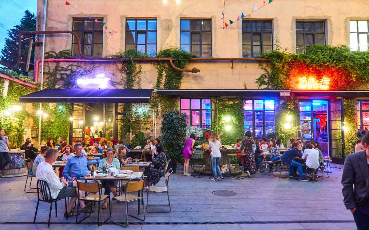 TBILISI, GEORGIA, Nightlife with People in Bars and Restaurants in the Courtyard of Fabrika Hostel