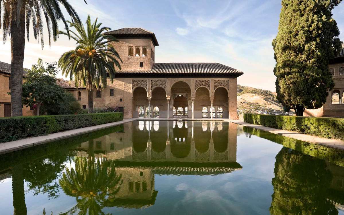 Alhambra Palace with perfect reflection in Granada, Spain