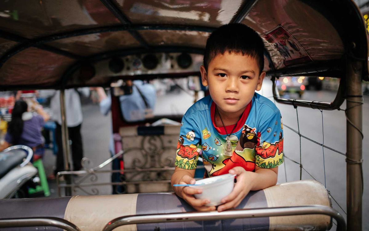 Boy on a tuk tuk in Bangkok, Thailand