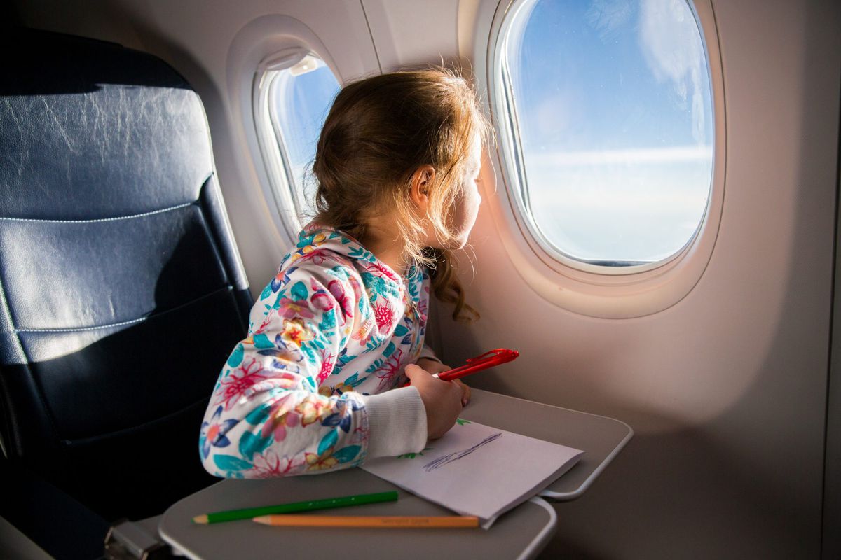Kid drawing on airplane