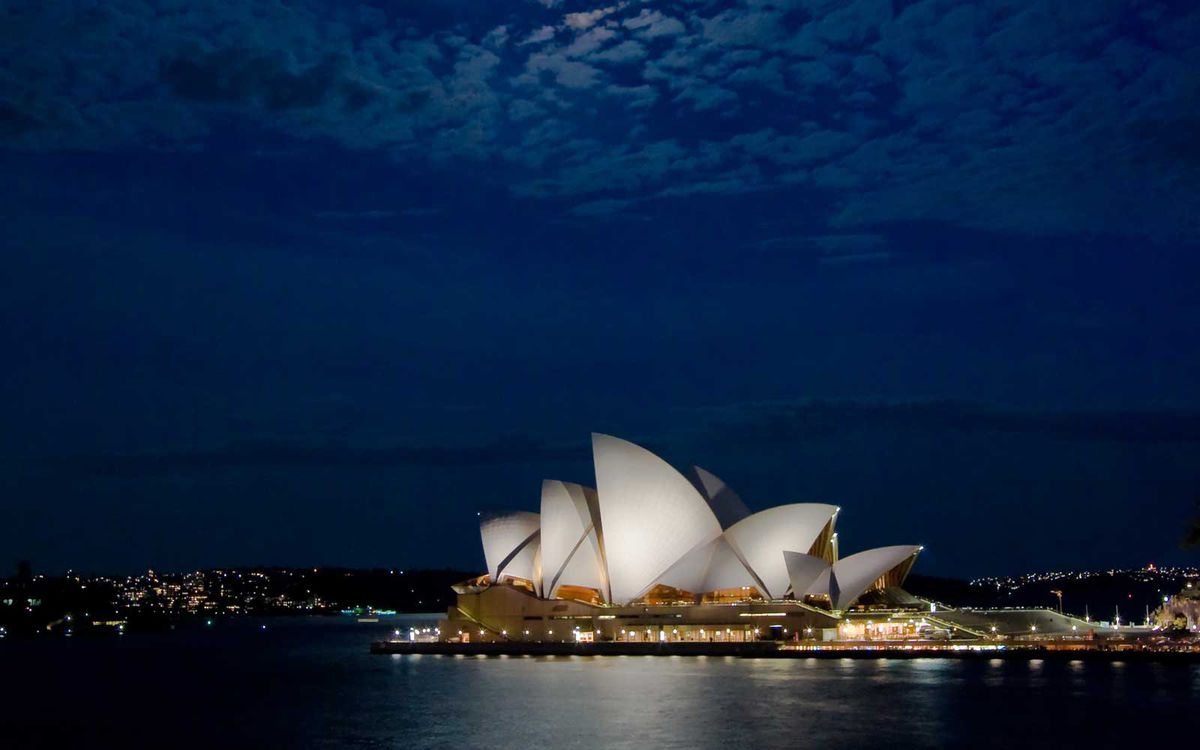Sydney Opera House lit under the moon