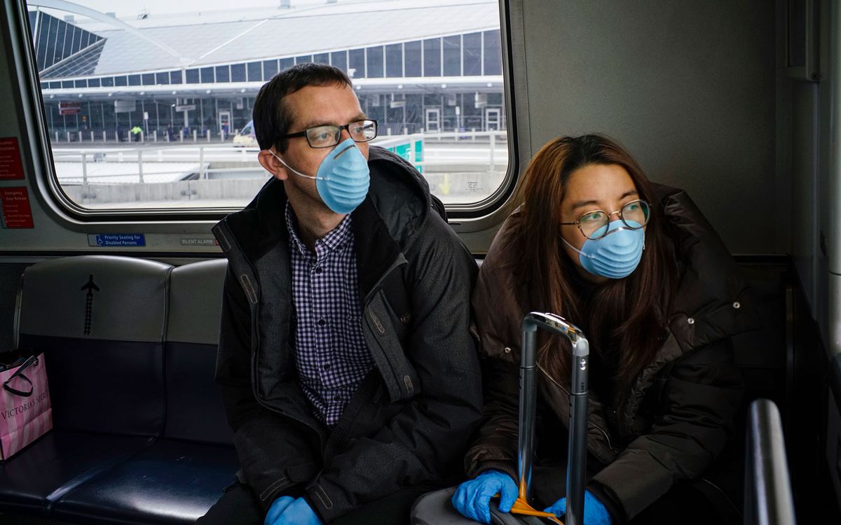 airport commuters wearing face masks