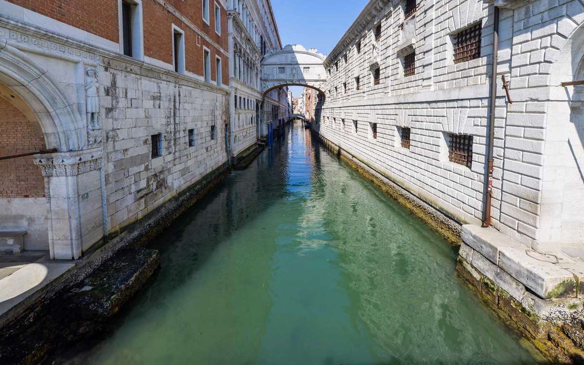 Clear waters below the Bridge of Sighs in a Venice canal on March 18, 2020
