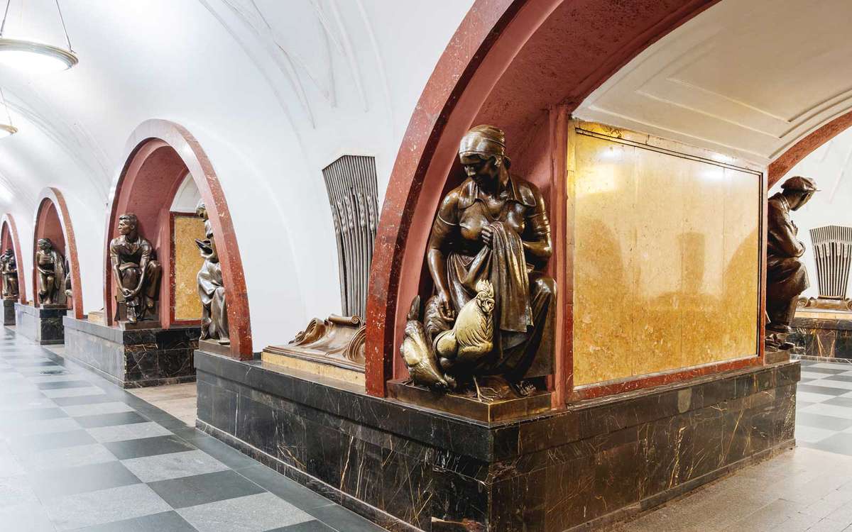Hall of Ploshchad Revolyutsii (Revolution Square) Moscow Metro station. Interior of underground transport system. Statues of people doing different things.