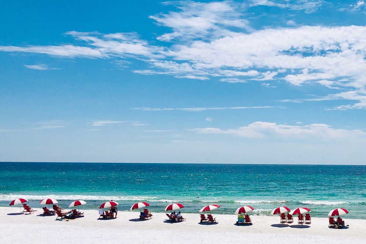 Row of beach chairs and umbrellas at Miramar Beach, Florida