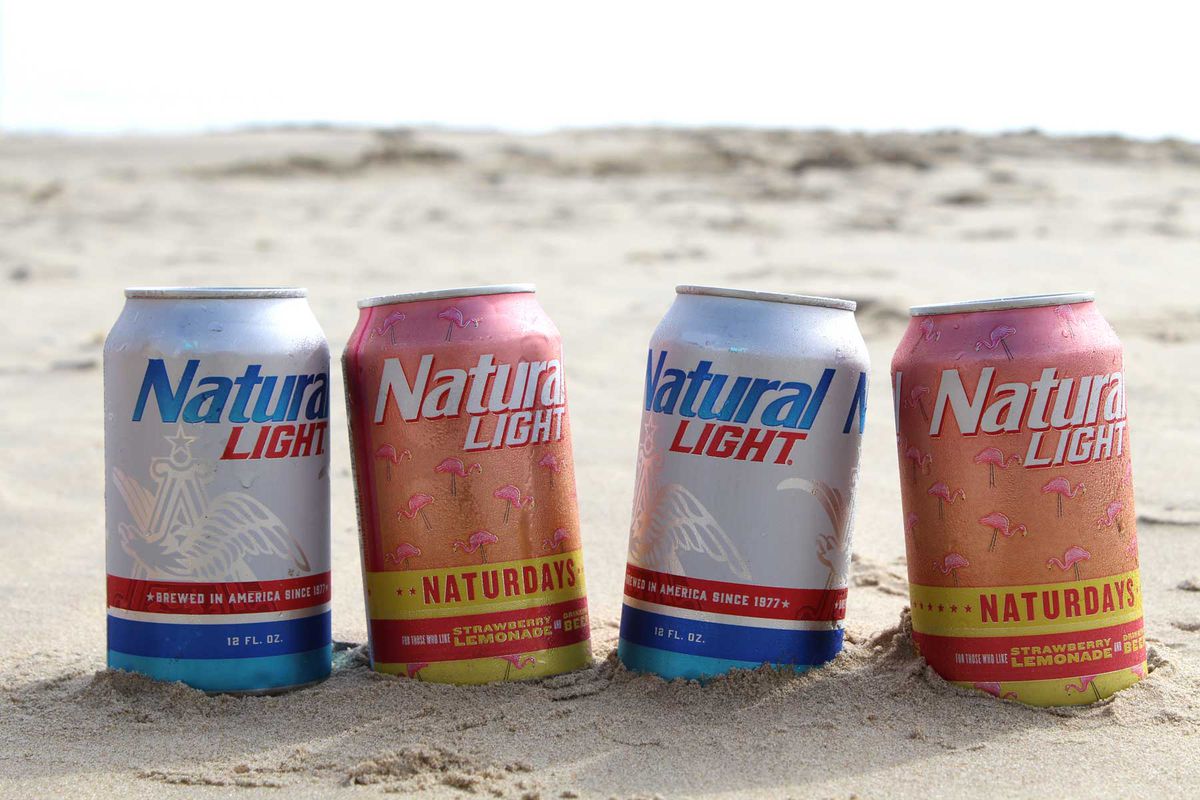 Cans of Natural Light Beer in the sand on a beach